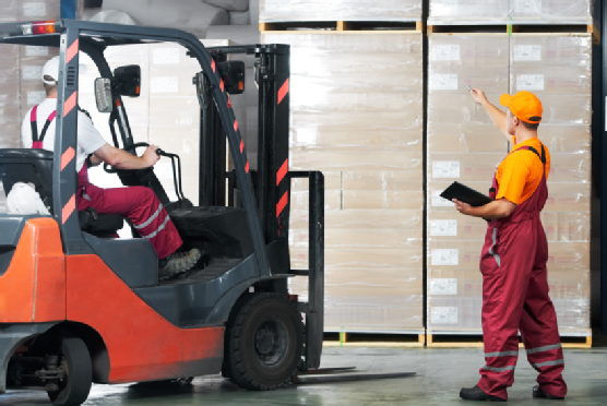 Man in forklift talking to another man while in a warehouse