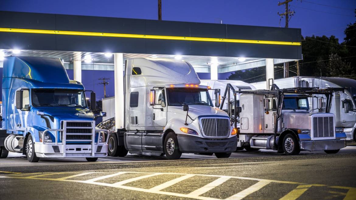 3 heavy haulers lined up under canopy looking for trucking jobs to take a northeast trucking company freight to destination