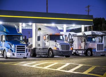 3 heavy haulers lined up under canopy looking for trucking jobs to take a northeast trucking company freight to destination