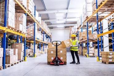 Woman in a 3pl warehouse in Rhode Island showing warehouse benefits like organization, cost reduction, and efficiency