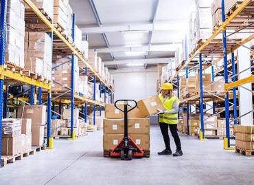 Woman in a 3pl warehouse in Rhode Island showing warehouse benefits like organization, cost reduction, and efficiency