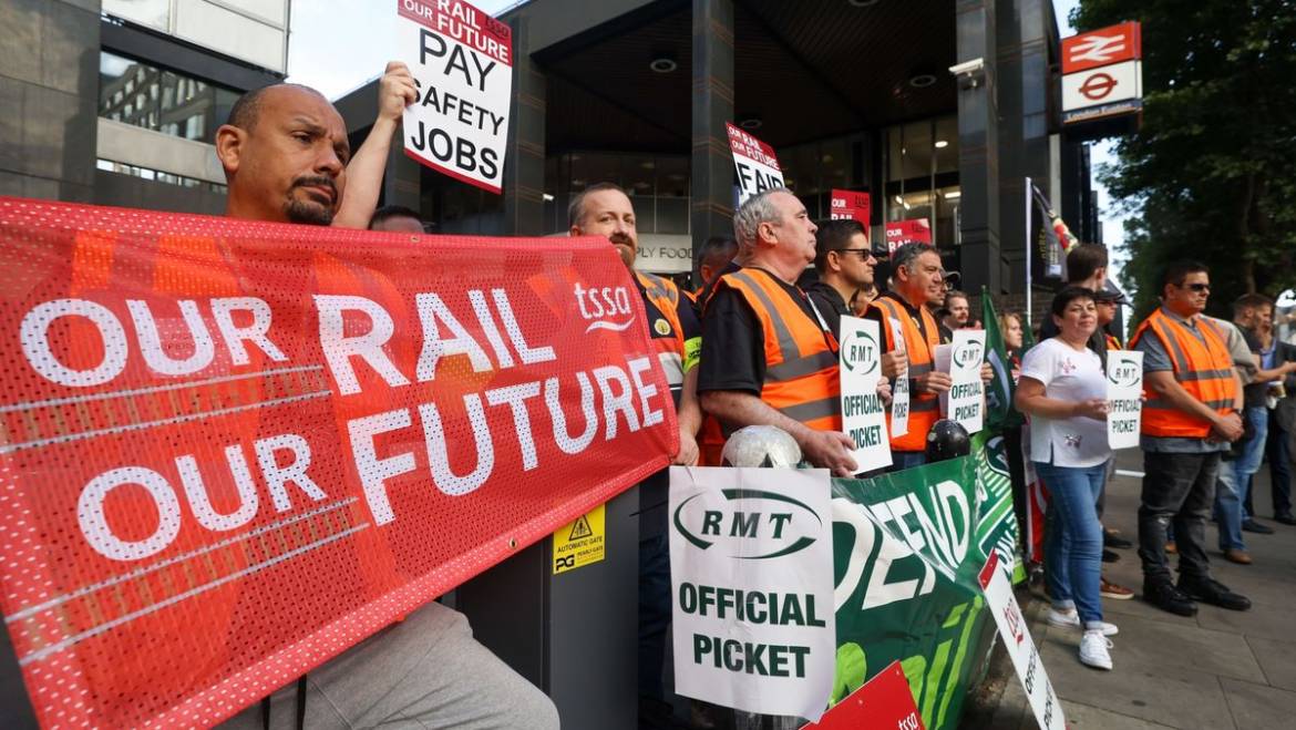 Rail strike workers picketing outside a railway. Rail workers demanding a new contract