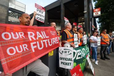 Rail strike workers picketing outside a railway. Rail workers demanding a new contract