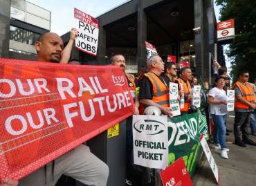 Rail strike workers picketing outside a railway. Rail workers demanding a new contract