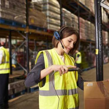 a rhode island warehouse worker using a warehouse management system to organize warehouse inventory