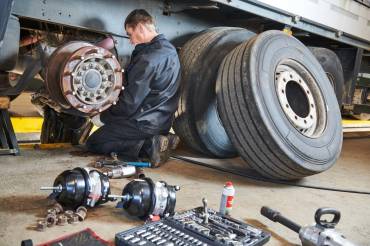 mechanic working on truck doing seasonal maintenace