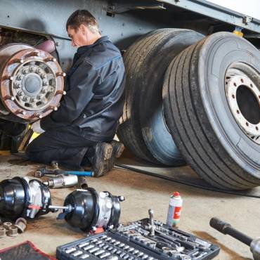 mechanic working on truck doing seasonal maintenace