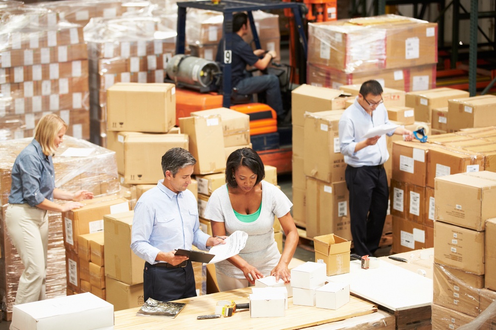 warehouse and inventory management being done by organizing racked storage by warehouse employees