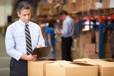 man checking to do list and doing warehouse and inventory management process