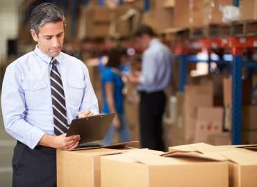 man checking to do list and doing warehouse and inventory management process