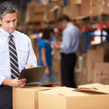 man checking to do list and doing warehouse and inventory management process