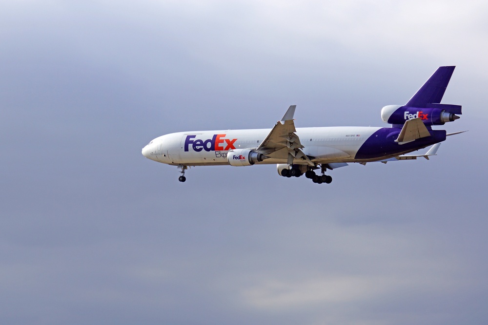 multi-carrier fedex plane flying through the air