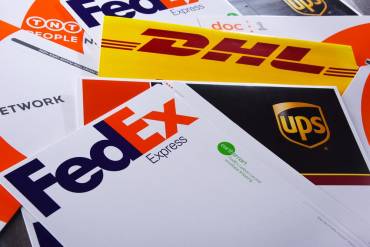 Multi carrier shipping with fedex, DHL, and UPS shipping packages on a table