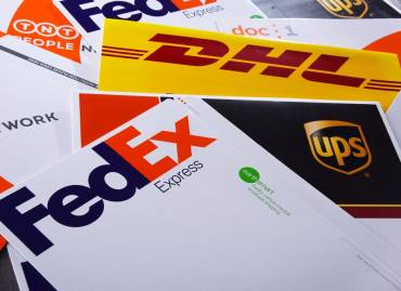 Multi carrier shipping with fedex, DHL, and UPS shipping packages on a table