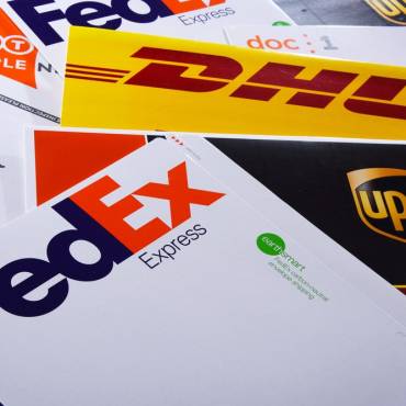 Multi carrier shipping with fedex, DHL, and UPS shipping packages on a table